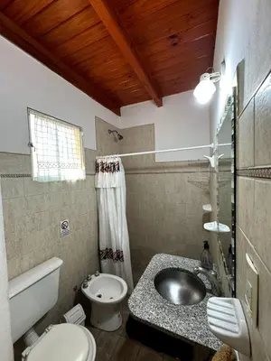 a bathroom with a sink and a toilet at Cabañas Mirador de la Bahia in Villa Ciudad Parque