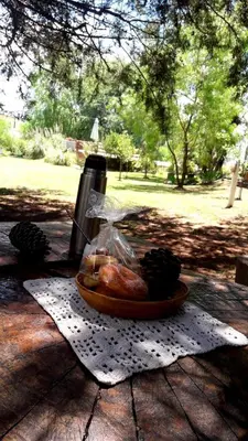 a plate of food on a table with a bag of food at Cabañas Mirador de la Bahia in Villa Ciudad Parque