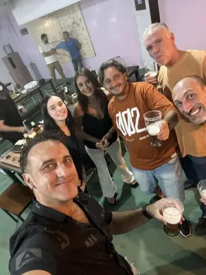 a group of people standing in a room with drinks at Wynwood Extreme Hostel in Villa Carlos Paz