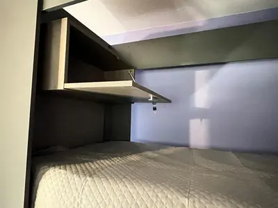 a small room with a bed and a ceiling at Wynwood Extreme Hostel in Villa Carlos Paz