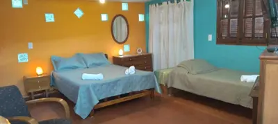 a bedroom with two beds and a mirror at Monoambiente Elegante in Los Hornillos