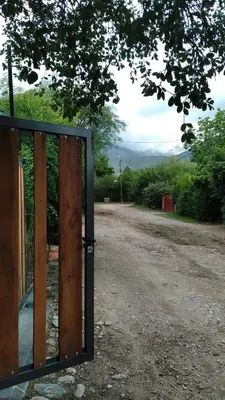 a wooden door in the middle of a dirt road at Monoambiente Elegante in Los Hornillos