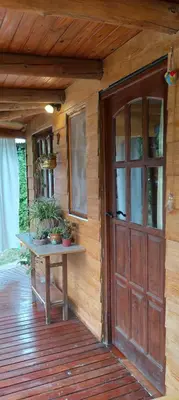 an entrance to a wooden house with a wooden door at Monoambiente Elegante in Los Hornillos