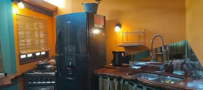 a kitchen with a refrigerator and a sink at Monoambiente Elegante in Los Hornillos