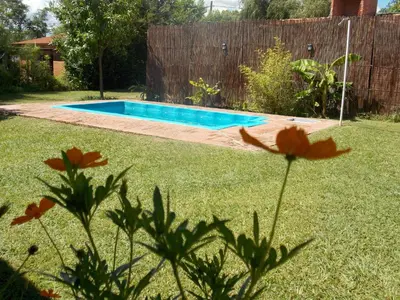 a backyard with a swimming pool in a yard at La cabañita de Maco in Nono