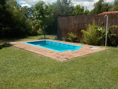 a small swimming pool in a yard at La cabañita de Maco in Nono