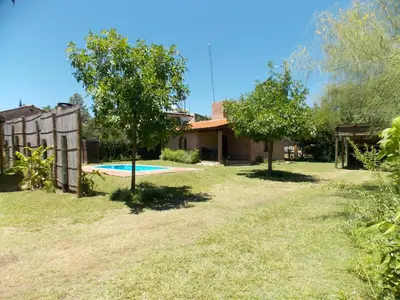 a house with a swimming pool in a yard at La cabañita de Maco in Nono