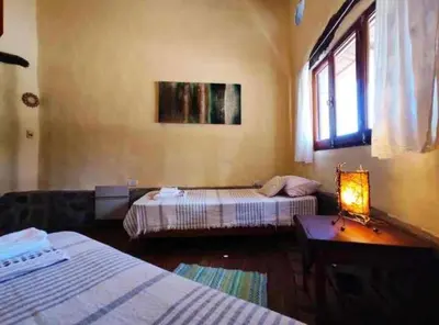 a bedroom with two beds and a table with a lamp at El Lugar in Travesía