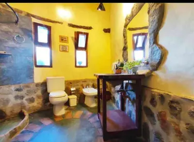 a bathroom with a toilet and a sink at El Lugar in Travesía