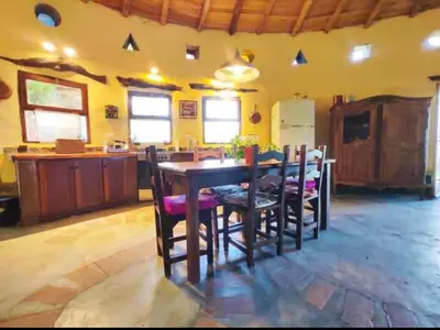 a kitchen and dining room with a table and chairs at El Lugar in Travesía