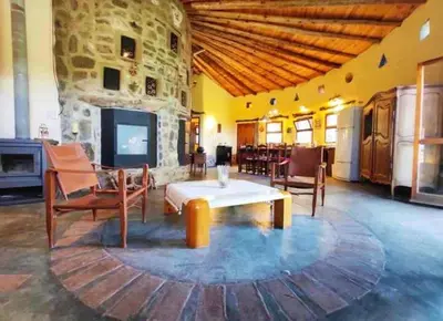 a living room with a table and chairs and a fireplace at El Lugar in Travesía