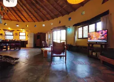 a living room with a flat screen tv and a couch at El Lugar in Travesía