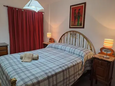 a bedroom with a bed with two towels on it at Temporarios Cordoba in Cordoba