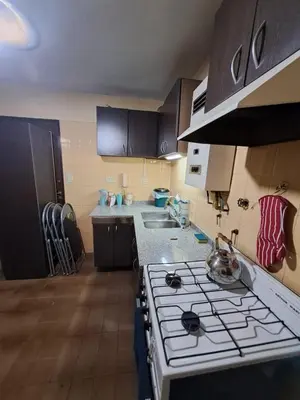 a kitchen with a stove top oven in a kitchen at Temporarios Cordoba in Cordoba