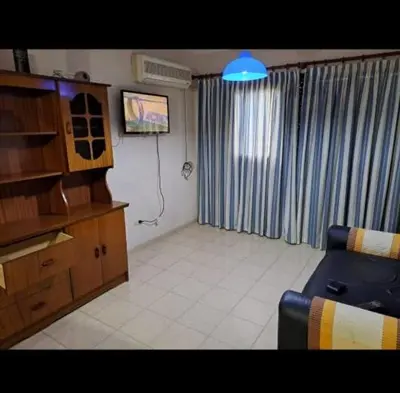 a living room with a couch and a tv at Temporarios Cordoba in Cordoba