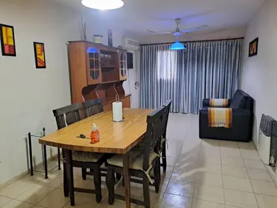 a dining room and living room with a table and chairs at Temporarios Cordoba in Cordoba