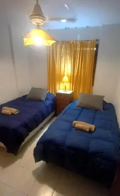two beds sitting next to each other in a bedroom at Temporarios Cordoba in Cordoba