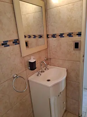 a bathroom with a sink and a mirror at PARQUE DEL SIERRAS in Alta Gracia