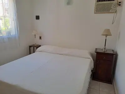 a bedroom with a bed and a dresser and a fan at PARQUE DEL SIERRAS in Alta Gracia