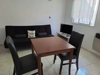 a living room with a table and a couch at PARQUE DEL SIERRAS in Alta Gracia