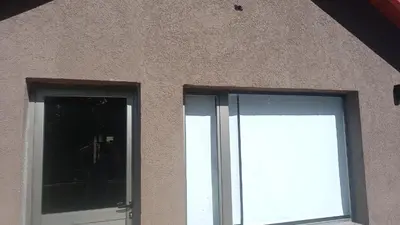 two windows on the side of a building at Sueños de Montaña in Villa Yacanto