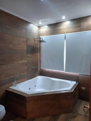 a large bath tub in a bathroom with a toilet at Sueños de Montaña in Villa Yacanto