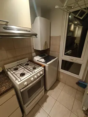 a small kitchen with a stove and a sink at ERA Residential Apartament in Cordoba