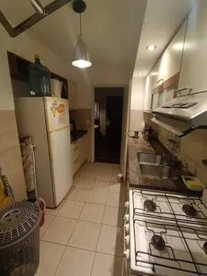 a kitchen with a white refrigerator and a sink at ERA Residential Apartament in Cordoba