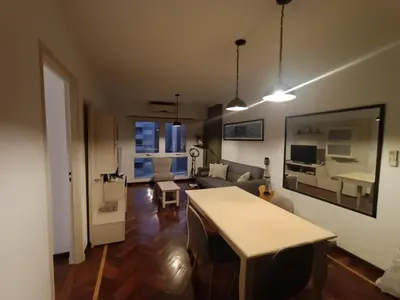 a living room with a table and a couch at ERA Residential Apartament in Cordoba