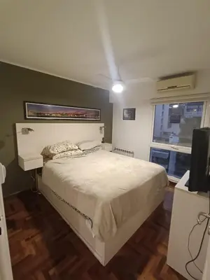 a bedroom with a bed and a television and a window at ERA Residential Apartament in Cordoba
