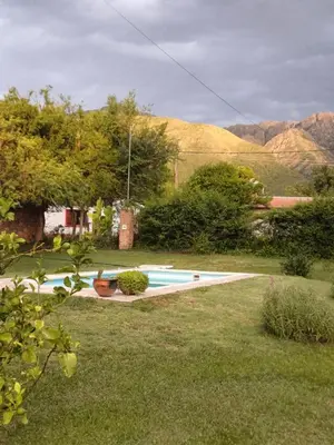 a swimming pool in a yard with mountains in the background at Las Guardia in Cortaderas