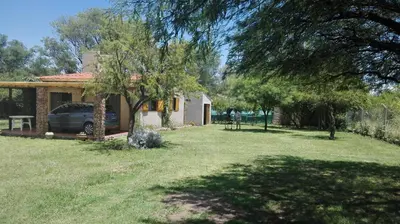 a house with a car parked in a yard at Las Guardia in Cortaderas