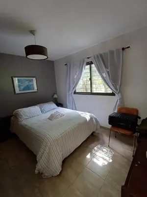 a bedroom with a large bed and a window at Las Guardia in Cortaderas