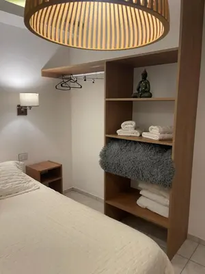 a bedroom with a bed and a lamp and towels at La carolina in Villa de Las Rosas