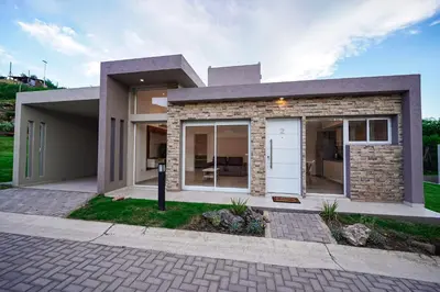 a rendering of a house with a driveway at Sunset Village in Villa Carlos Paz