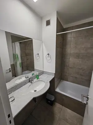 a bathroom with a sink and a bath tub at Depto con Vista PANORAMICA FRENTE CENTRO CIVICO - UBICACION INMEJORABLE in Cordoba