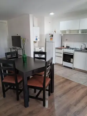 a kitchen with a black table and chairs and a stove at Depto con Vista PANORAMICA FRENTE CENTRO CIVICO - UBICACION INMEJORABLE in Cordoba