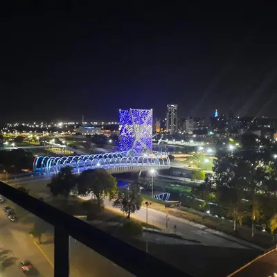 a view of a city at night with blue lights at Depto con Vista PANORAMICA FRENTE CENTRO CIVICO - UBICACION INMEJORABLE in Cordoba