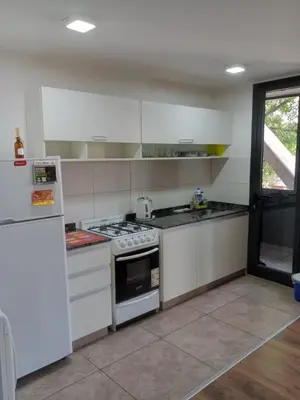 a kitchen with a stove and a refrigerator at Depto con Vista PANORAMICA FRENTE CENTRO CIVICO - UBICACION INMEJORABLE in Cordoba