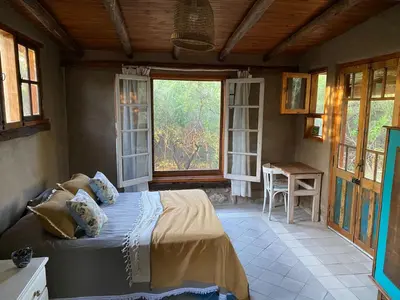 a bedroom with a bed in a room with windows at Hexágono de San Javier in San Javier