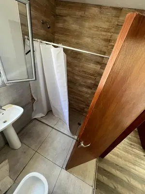 a bathroom with a shower and a toilet and a sink at Duplex en plena montaña in Villa Carlos Paz