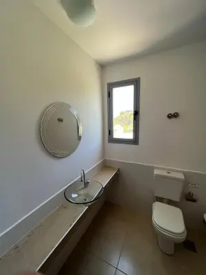 a bathroom with a sink and a toilet and a mirror at Duplex en plena montaña in Villa Carlos Paz