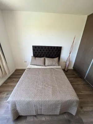 a bedroom with a large bed with a black headboard at Duplex en plena montaña in Villa Carlos Paz