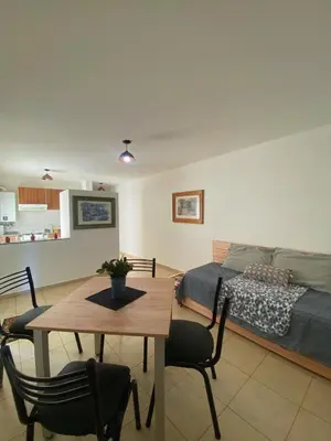 a living room with a table and a bed at SANTA ROSA in Cordoba