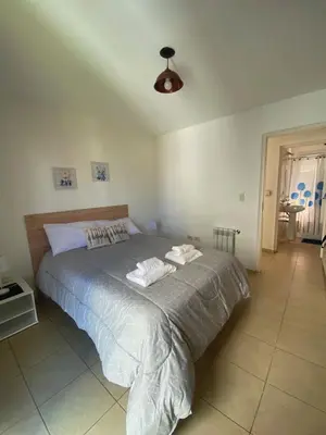 a bedroom with a bed with two towels on it at SANTA ROSA in Cordoba