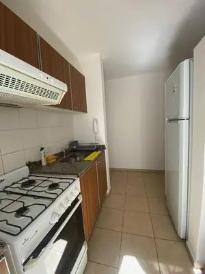 a kitchen with a stove and a refrigerator at SANTA ROSA in Cordoba