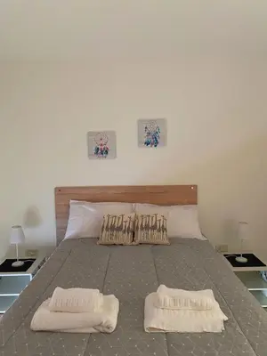a bedroom with a bed with two pillows on it at SANTA ROSA in Cordoba