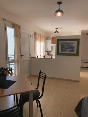a living room with a table and a dining room at SANTA ROSA in Cordoba