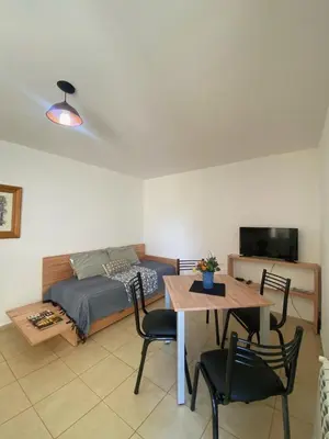 a bedroom with a bed and a table and chairs at SANTA ROSA in Cordoba