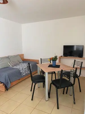 a bedroom with a table and chairs and a bed at SANTA ROSA in Cordoba